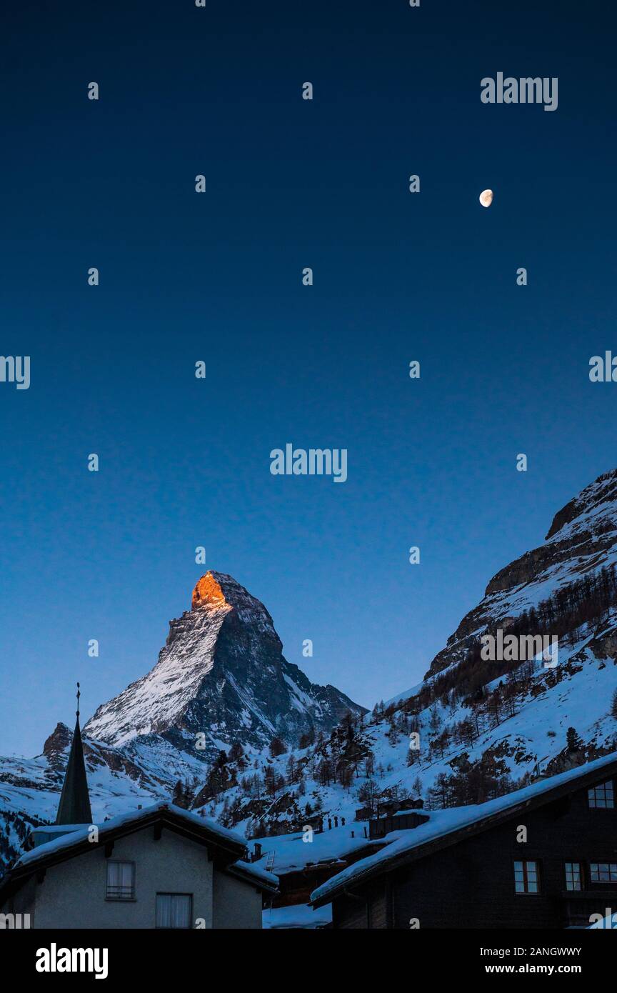 Sunrise On Matterhorn With Alpenglow And Moon In Winter Stock