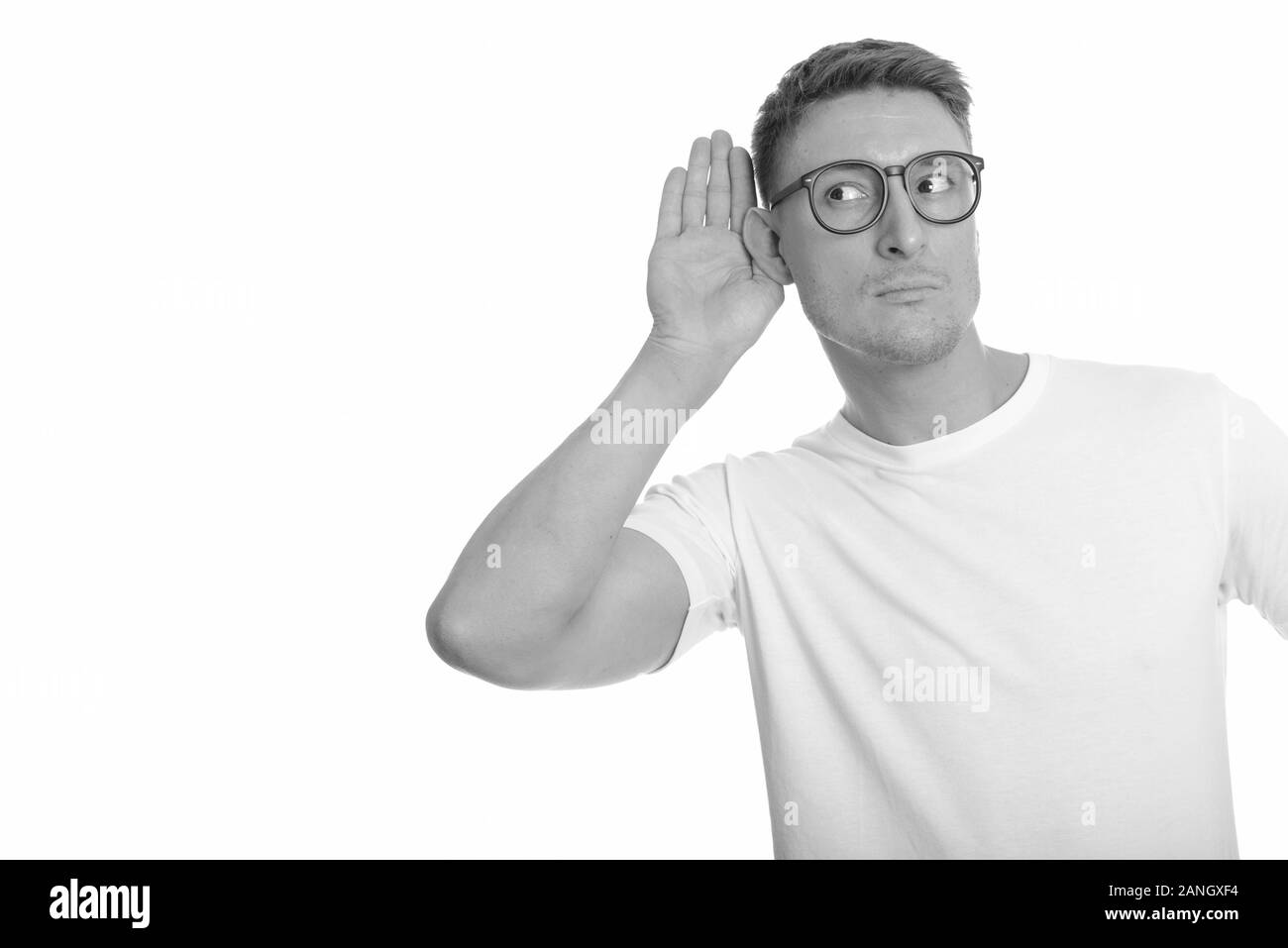 Portrait of young handsome nerd man thinking and listening Stock Photo