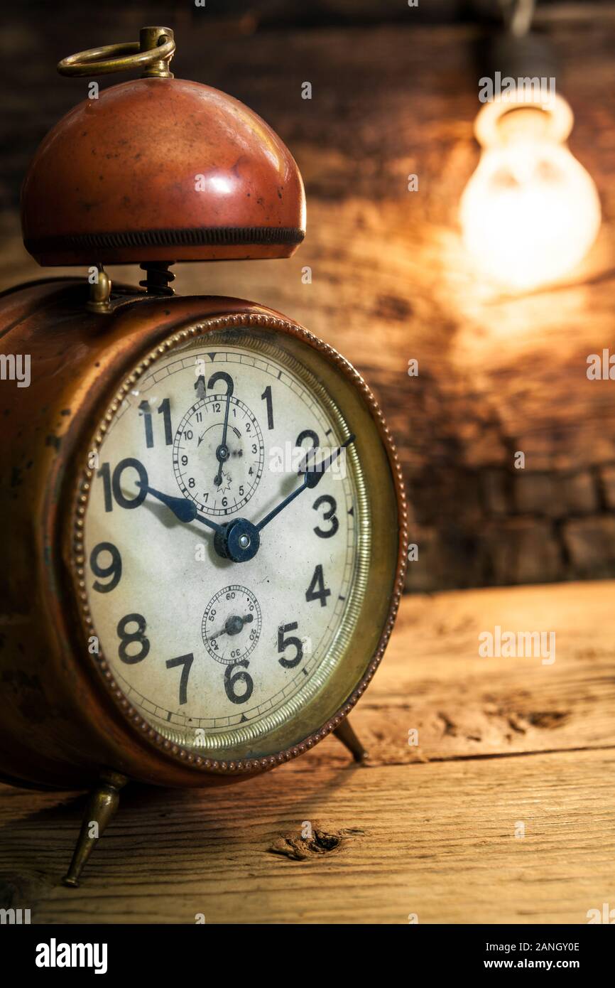 old alarm clock with incandescent light bulb close up Stock Photo Alamy