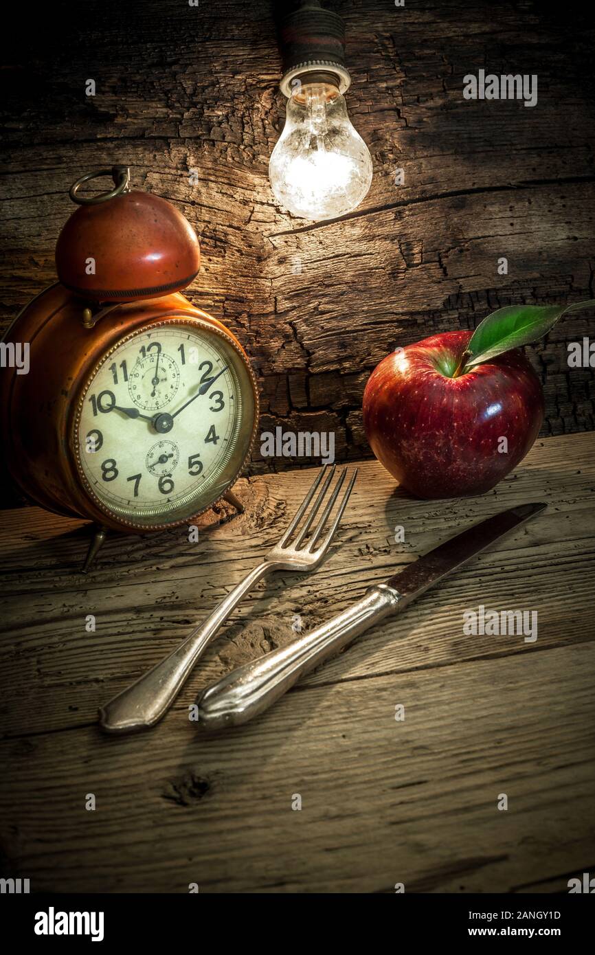 old alarm clock with incandescent light bulb Stock Photo Alamy