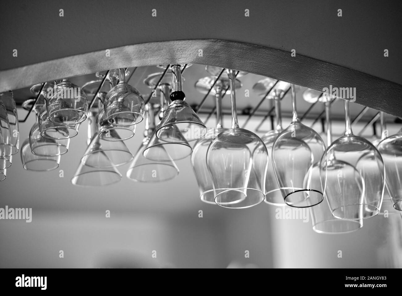 Wine and cocktail glasses hanging on rack Stock Photo Alamy