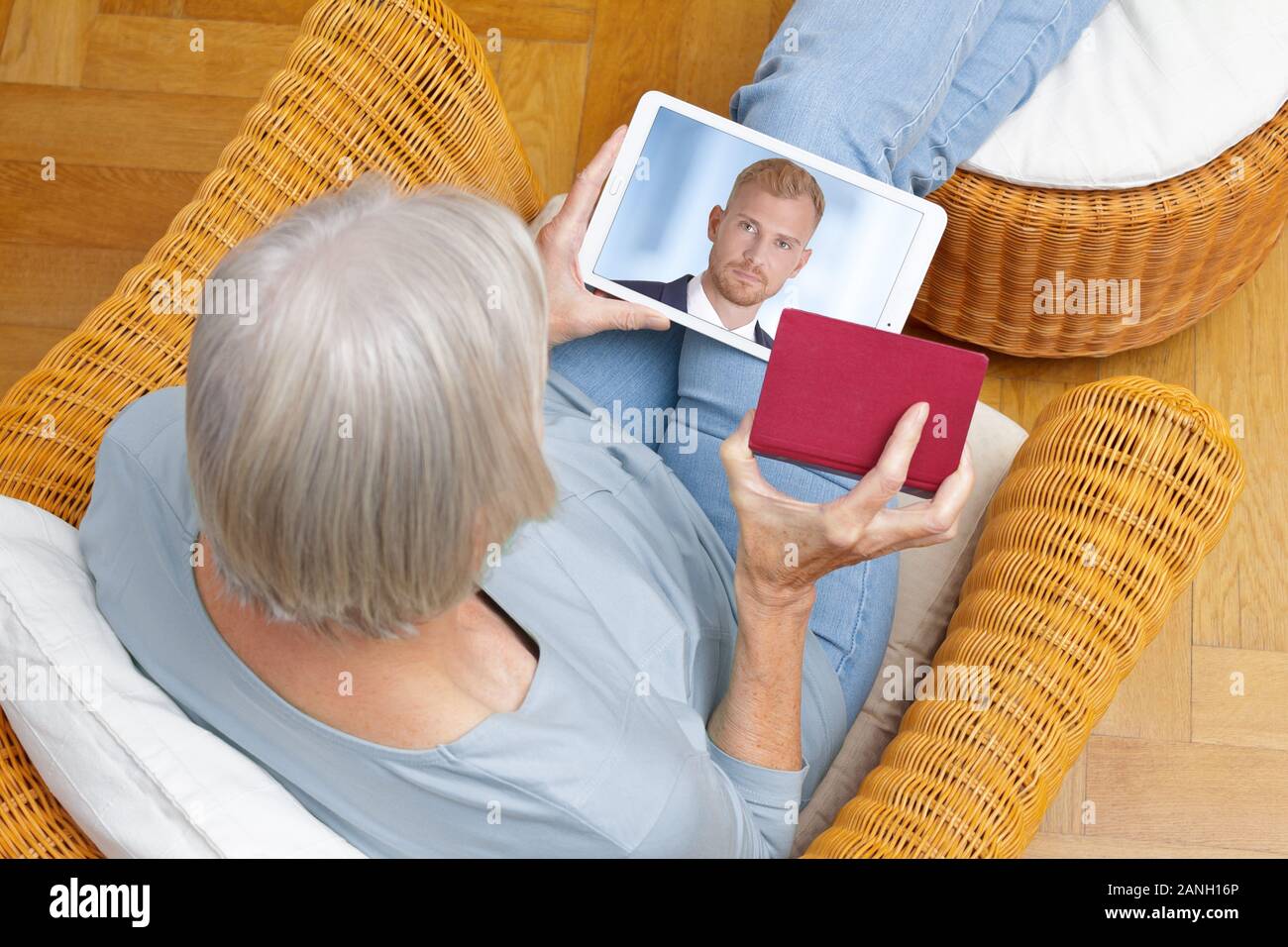 e-id concept: senior woman using a video identification service to open a new bank account with her tablet computer Stock Photo