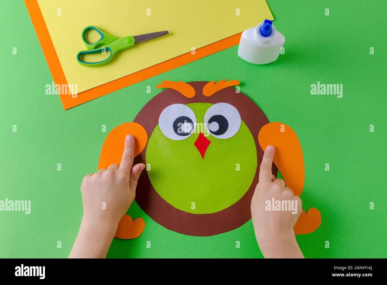 kid is making a owl with color paper, glue and scissors Stock Photo Alamy