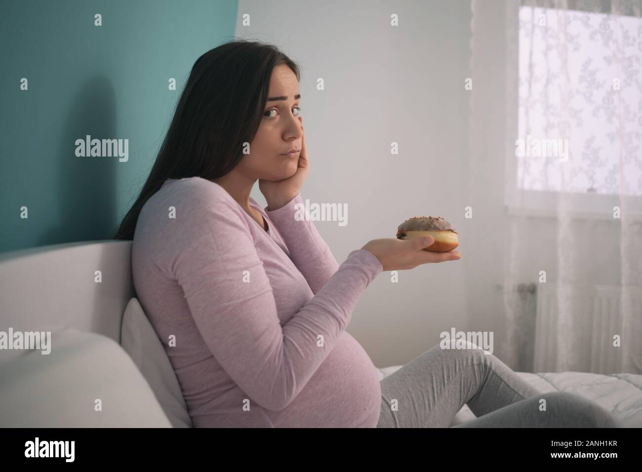 Pregnant woman is sad because she can not eat candies Stock Photo Alamy