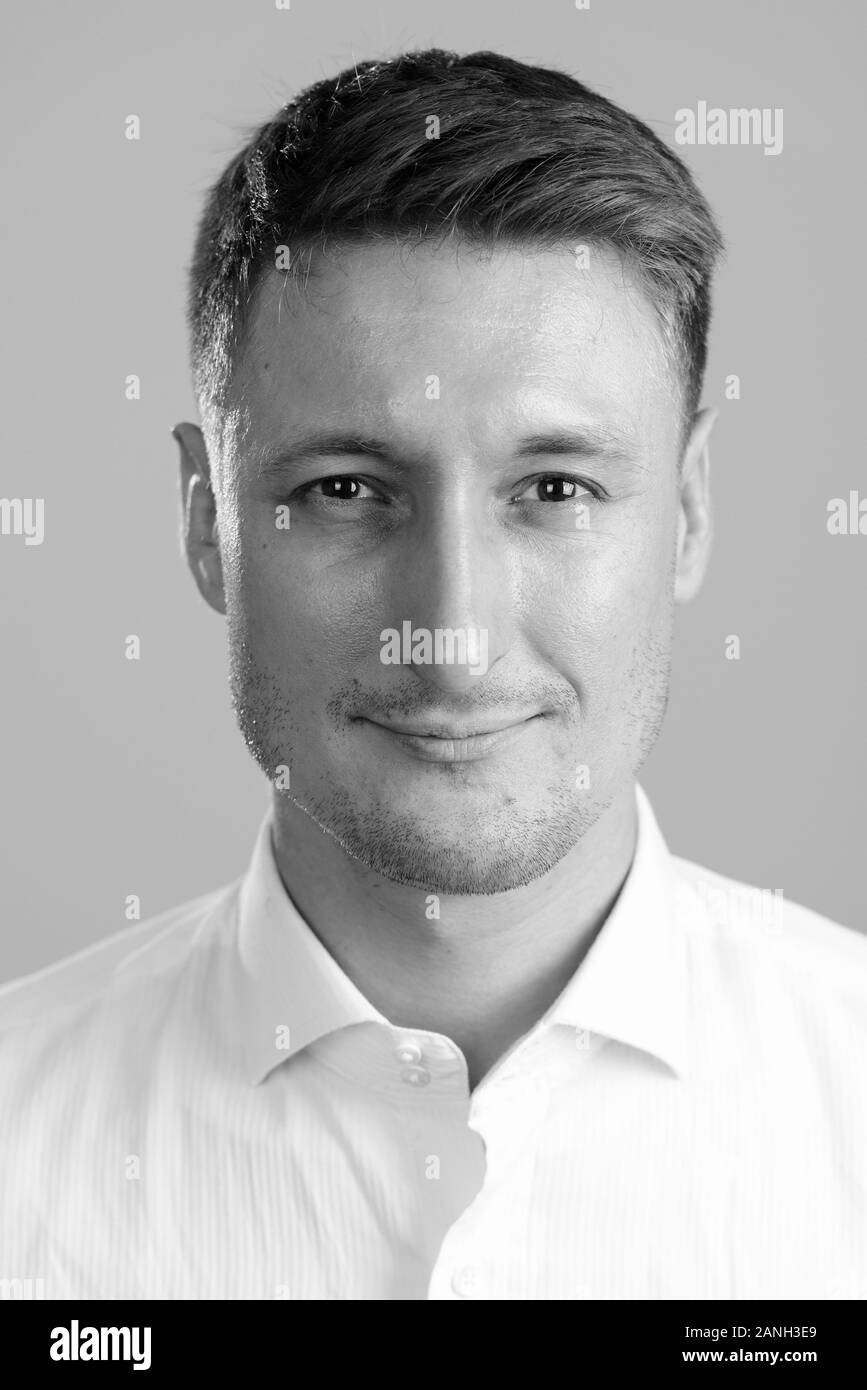 Face of young handsome businessman looking at camera Stock Photo - Alamy