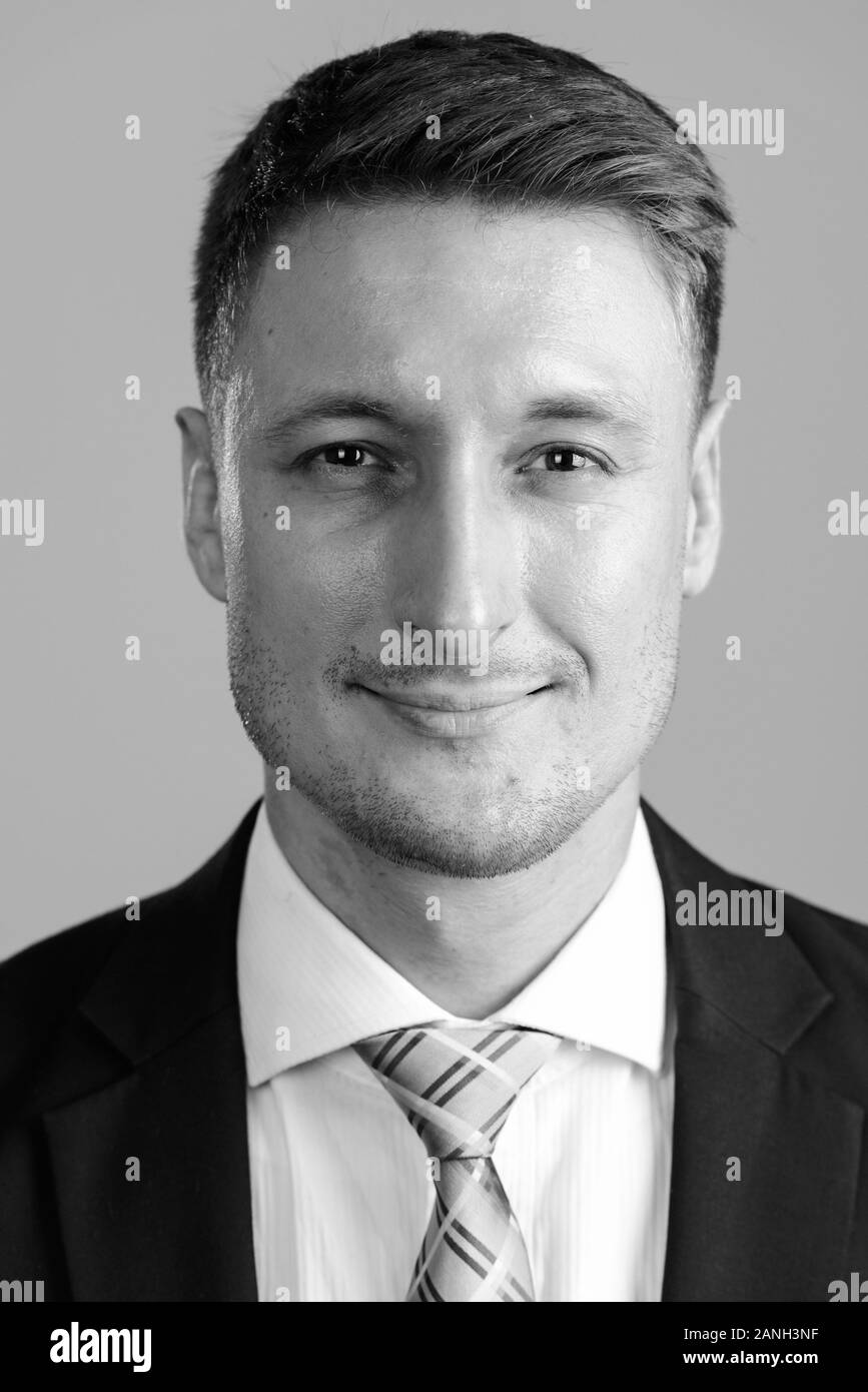 Face of young handsome businessman in suit looking at camera Stock ...