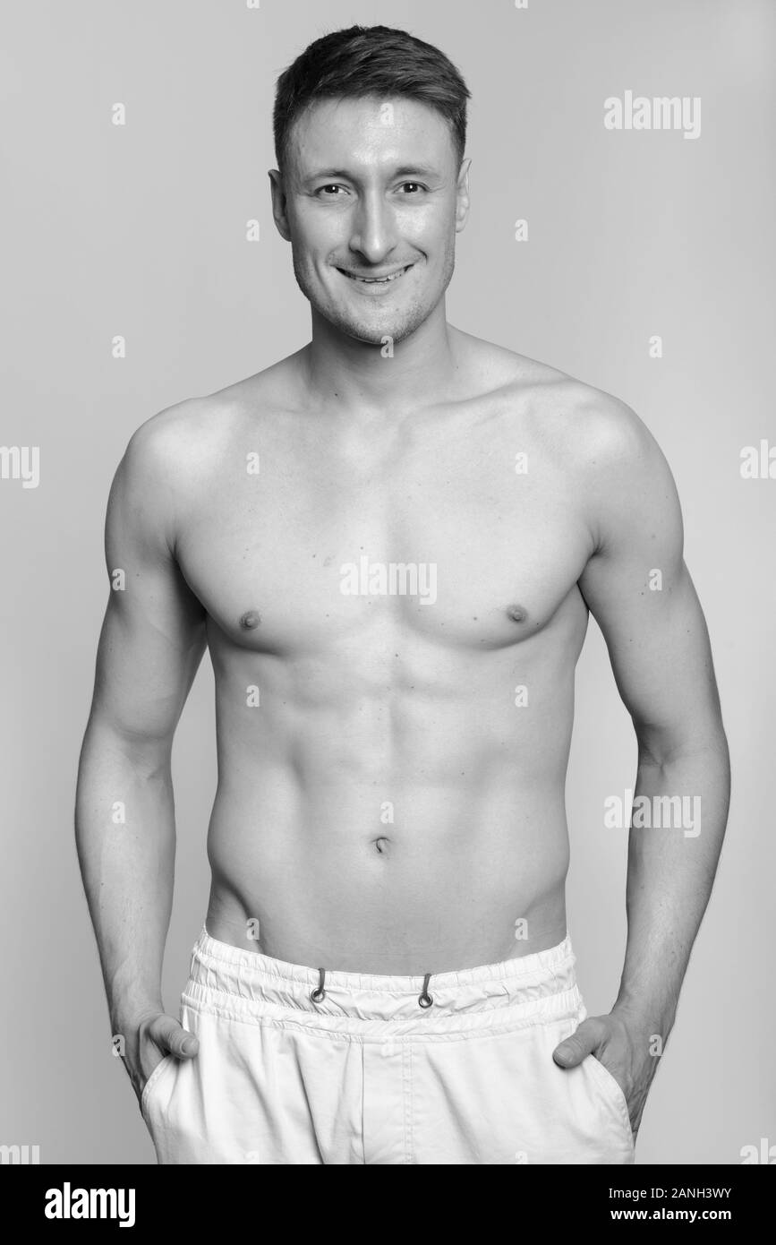 Portrait of happy young handsome muscular man smiling shirtless Stock ...