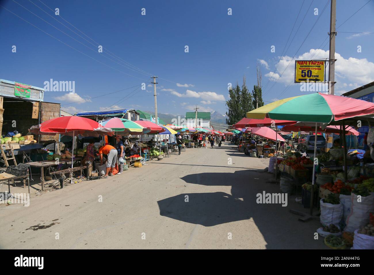 A regular street in town center Karakol - one of the bigest and busiest streets of Kyrgyzstan - Karakol Stock Photo