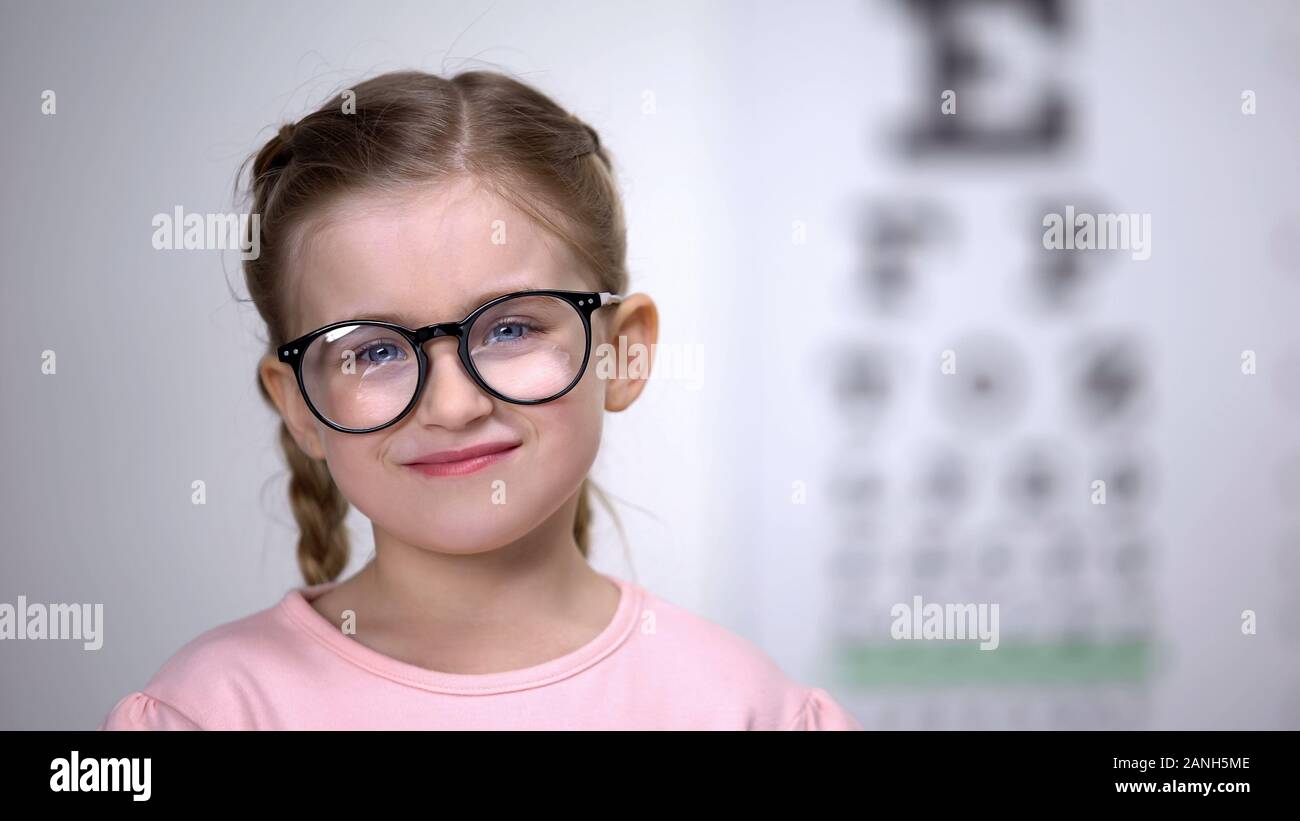 Adorable child in eyeglasses smiling into camera vision correction for children Stock Photo
