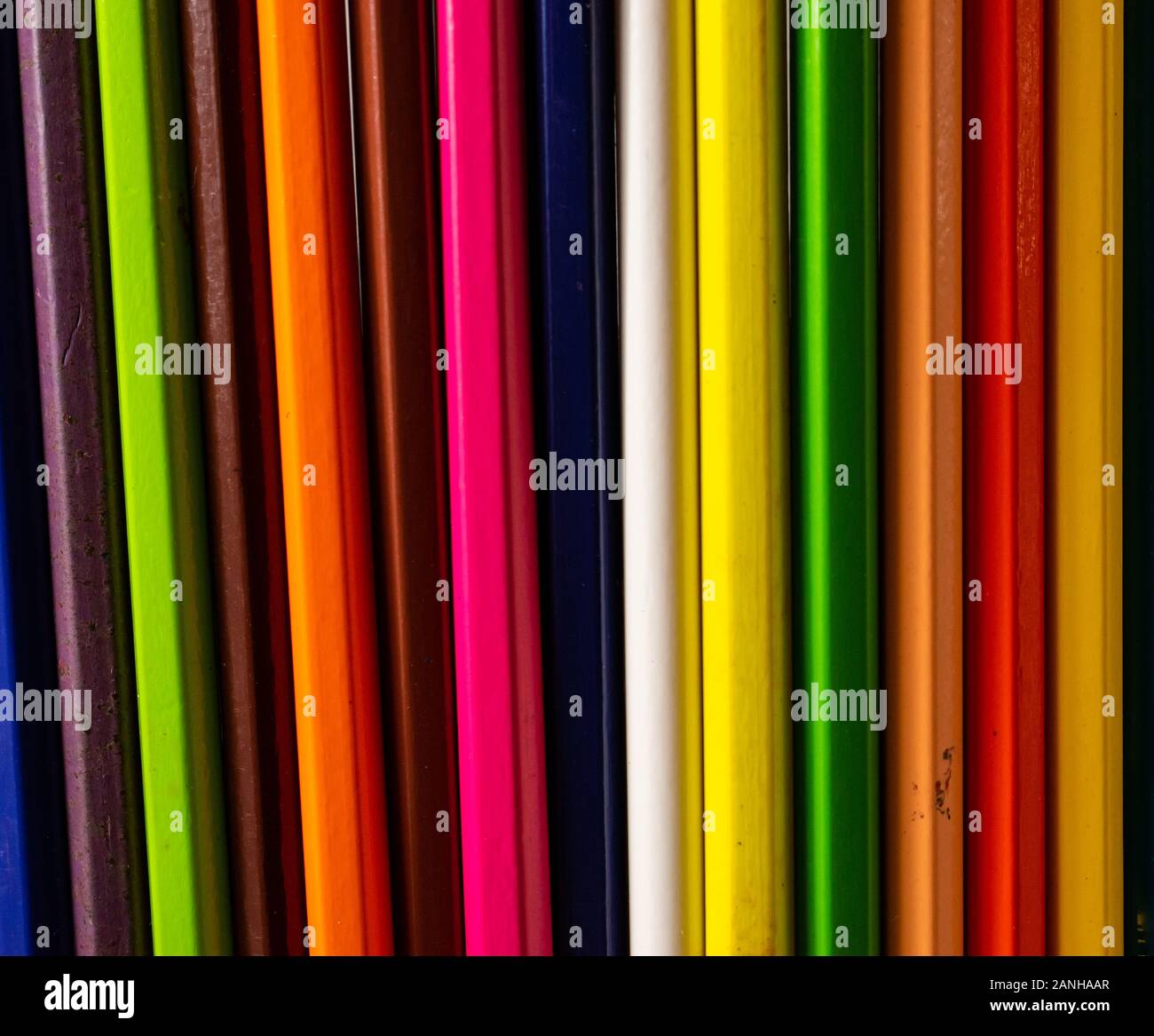 Different colors of pencils, in a straight line pattern. Colored crayons arranged in a meaningful way. Stock Photo