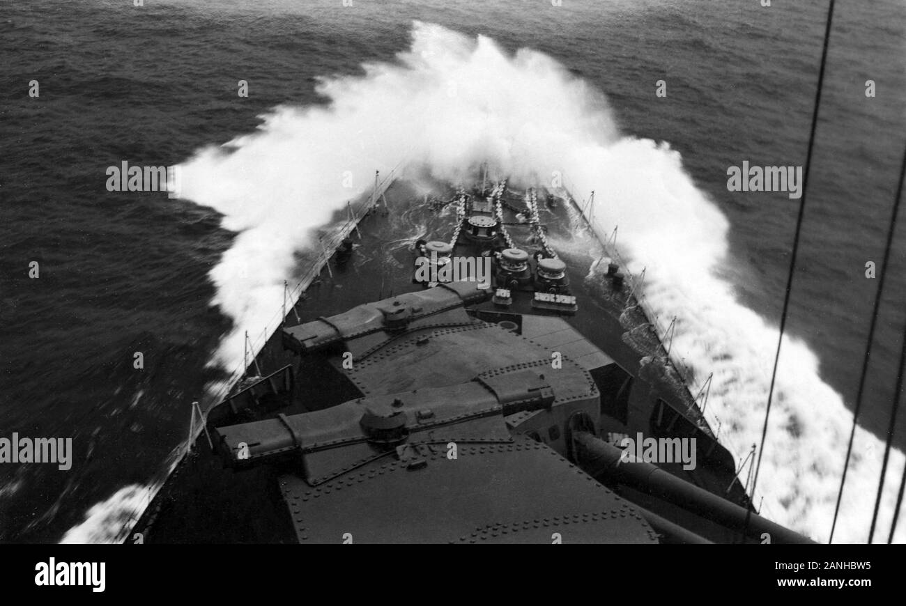 A huge wave breaks over the bow of HMS Nelson a British Battleship of the Nelson Class. Stock Photo