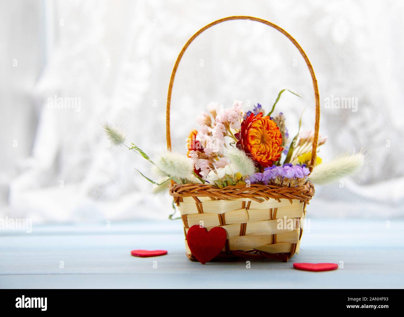 Dried blue flowers and wheat, wicker chairs in dining room with big glass  table and decorations. Cozy, vintage, rustic atmosphere at home. Concept of  Stock Photo - Alamy