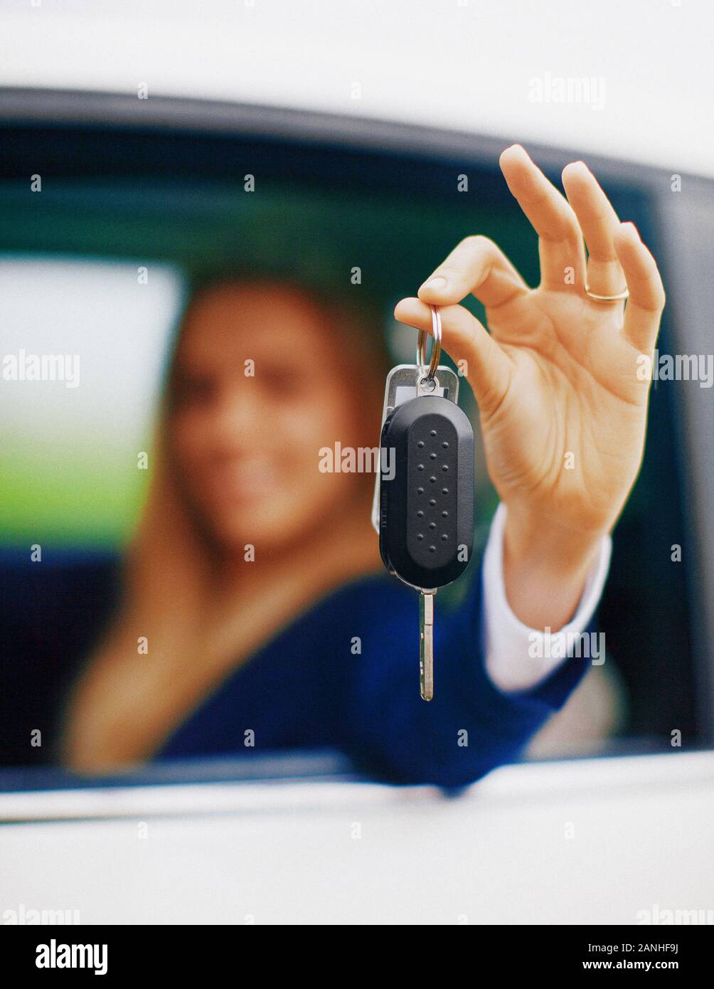 Young blonde woman in her new car smiling. Stock Photo