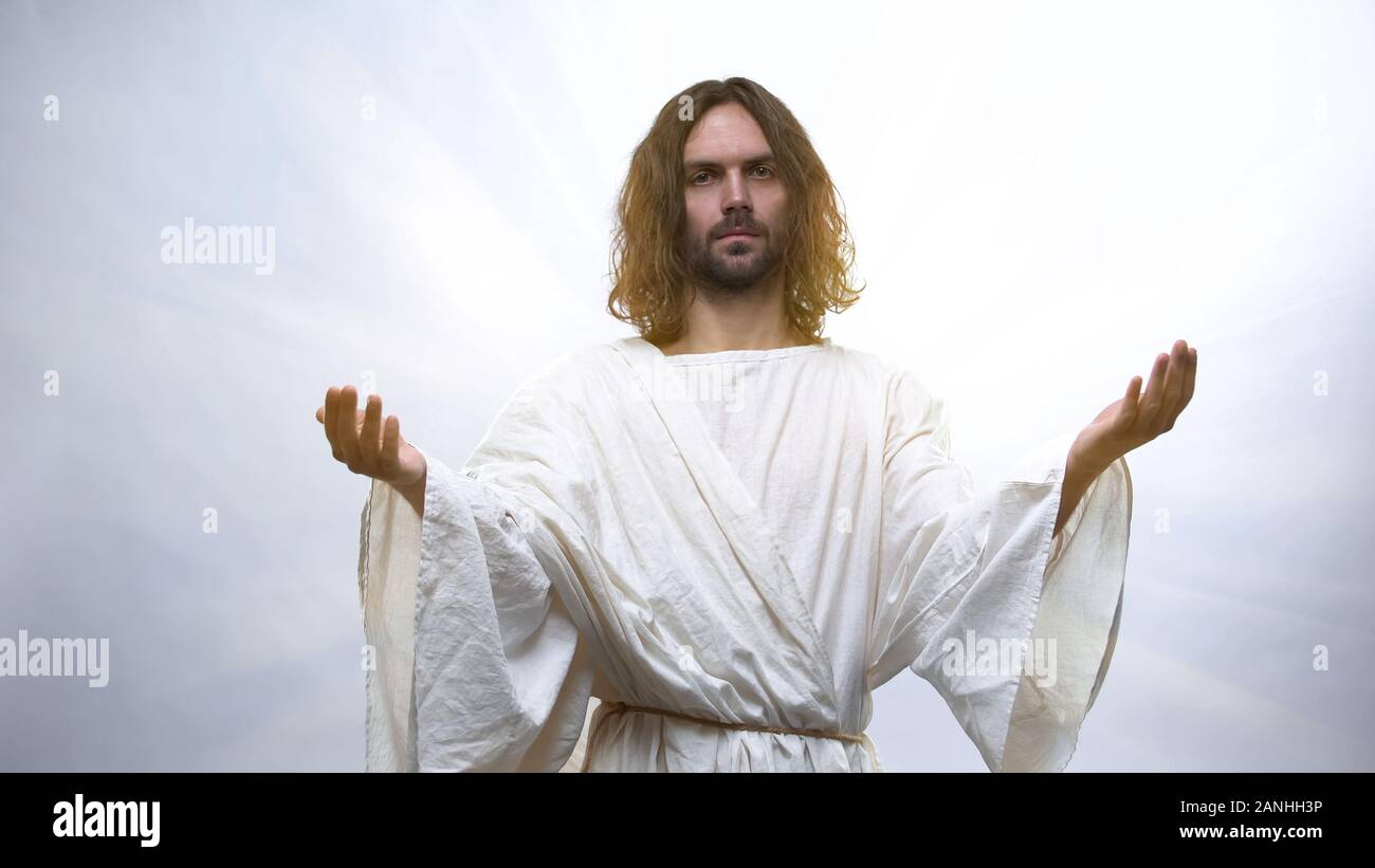 Person dying and looking at Jesus in light, God welcoming man soul to heaven Stock Photo