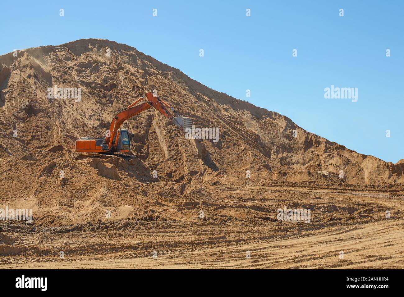 Excavator loading sand at big construction site Stock Photo