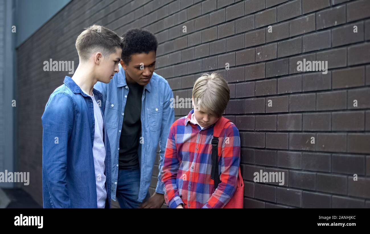 Cruel high school students bullying junior boy, verbal abuse