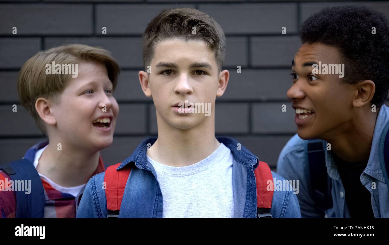 Student boldly looking into camera, resisting verbal bullying of classmates Stock Photo