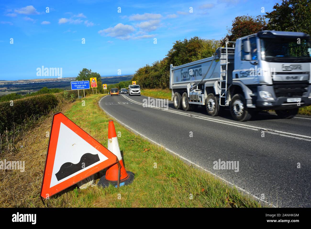 lorry passing warning sign of bumpy road surface/potholes in road ahead staxton yorkshire yorkshire united kingdom Stock Photo