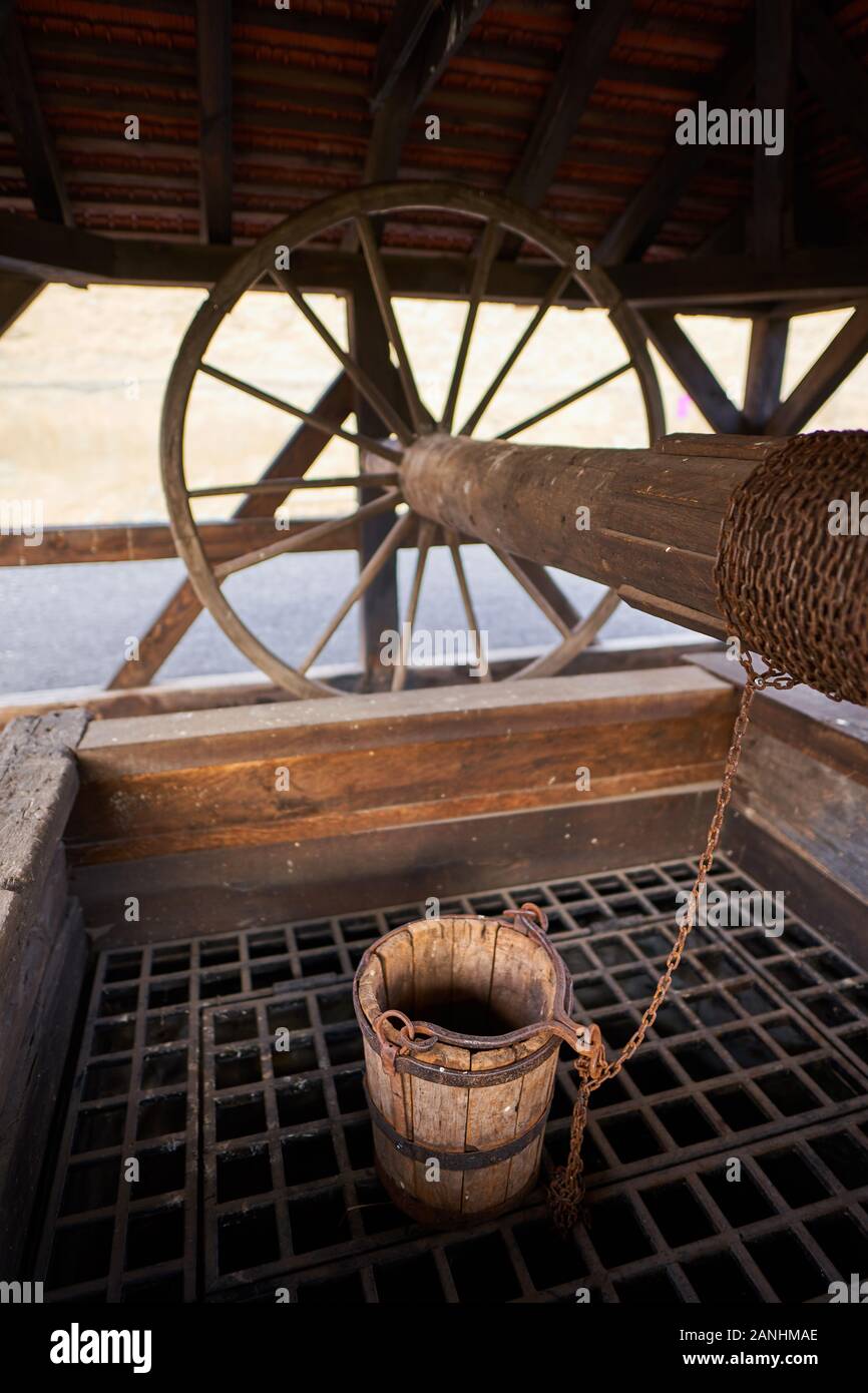 Wooden well with pulley and bucket Stock Photo Alamy