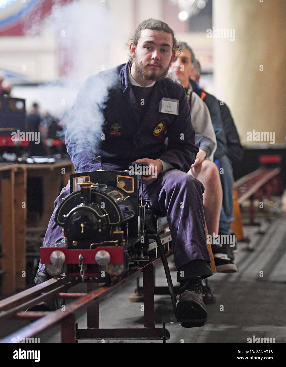 Enthusiasts ride on a model Molly Ann steam train at the London Model