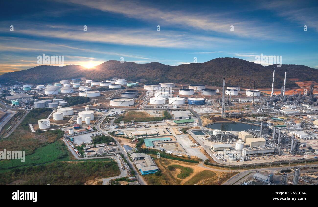 Panoramic view of the oil and gas refinery industry, with mountains in the background at dusk Stock Photo