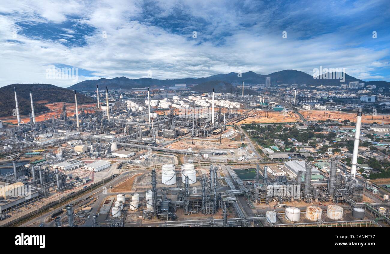 Panoramic view of the oil and gas refinery industry, with mountains in the background at dusk Stock Photo