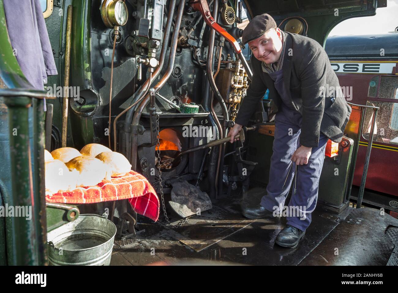 On board steam locomotive cab, driver cooking breakfast for the crew. Stock Photo
