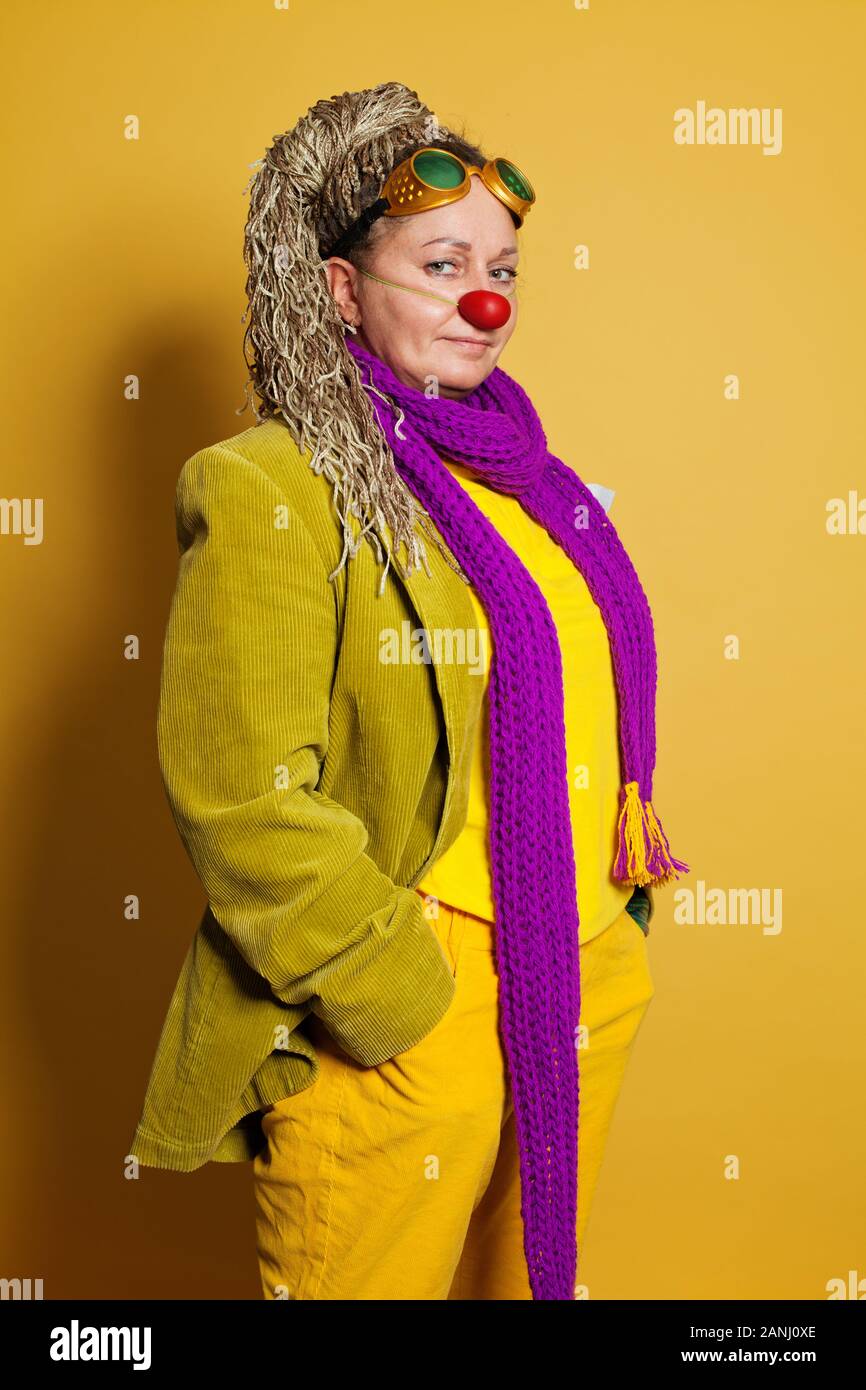 Smiling mature woman clown on yellow background Stock Photo - Alamy