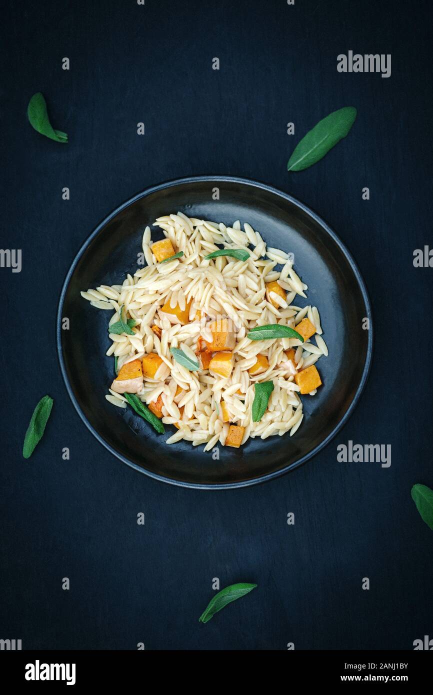Vegan main course Orzo Pasta with Butternut squash and sage. Vegarian