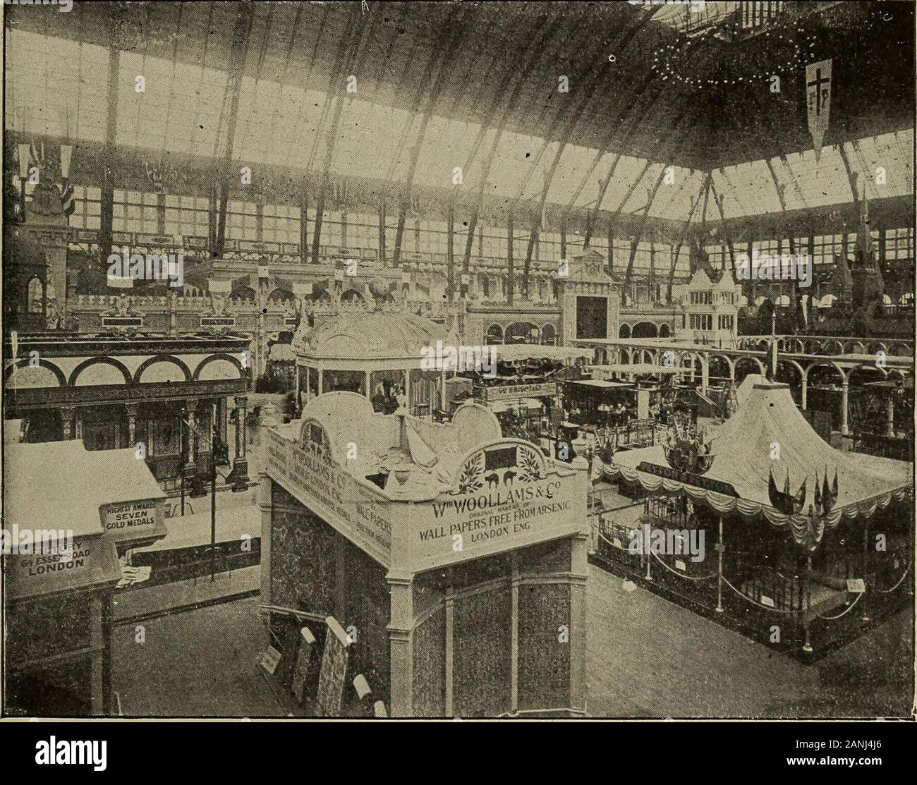 The World's Columbian exposition, Chicago, 1893 . BOOKING OVKR CLOTH BOOTHS TO CLOCK TOWER. of the States with their coats-of-arms, and gigantic eagles with up-lifted wings are poised on the pedmients over the entrances. Through the centre of the buildincr north and south, from entranceto entrance, runs a veritable street, Columbia avenue, fifty feet wideand studded at the corners of each intersecting street or aislewith ornamental lamp-posts bearing electric lights. Across this MANUFACTURES. 103 Street at Its middle runs another of the same width, thus dividingthe interior of the building int Stock Photo