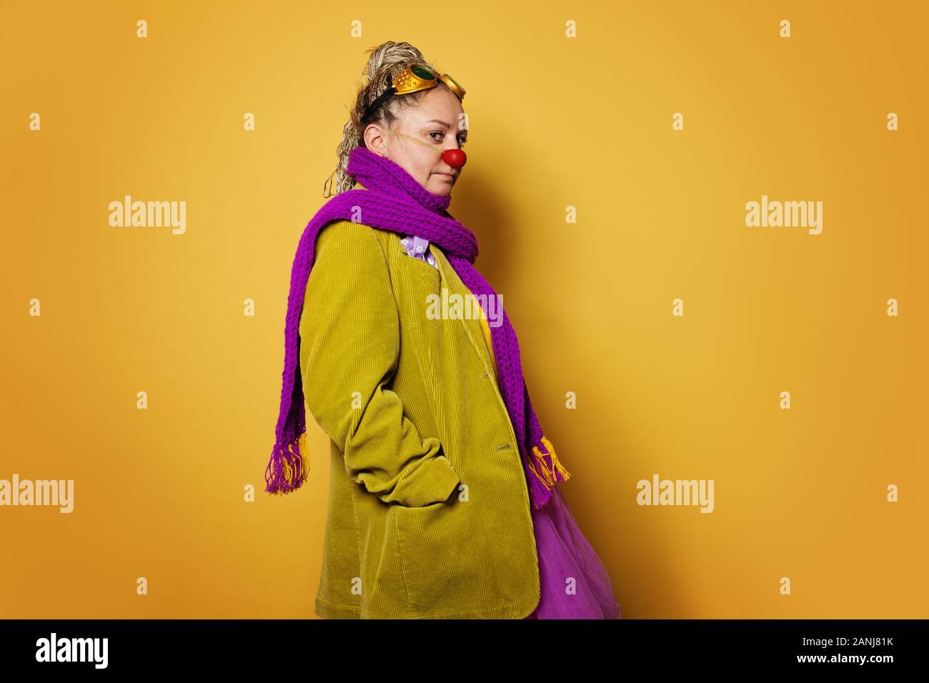 Actress woman wearing colorful clown costume on vivid yellow background ...