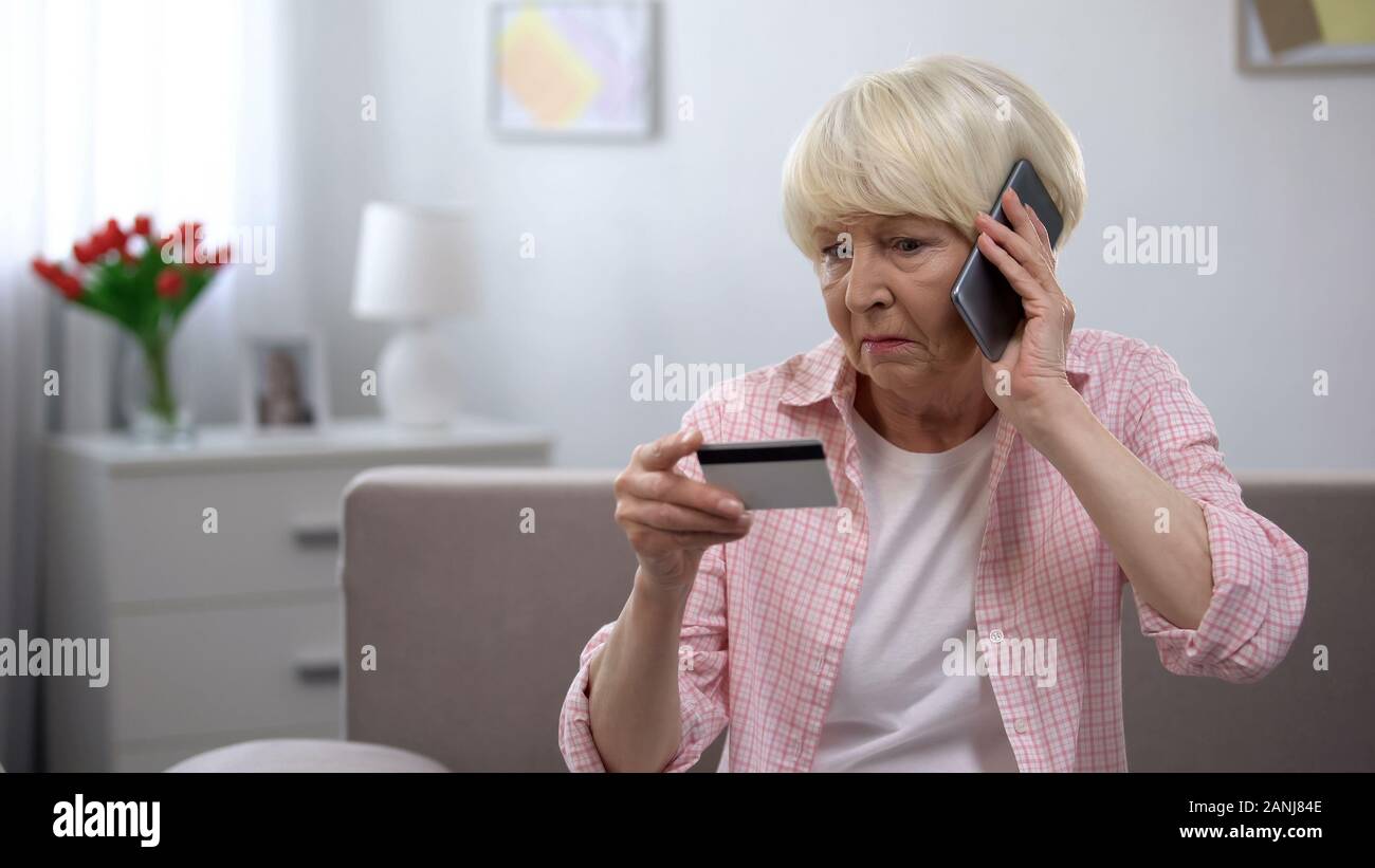 Aged woman calling children asking for help with using banking card, generation Stock Photo