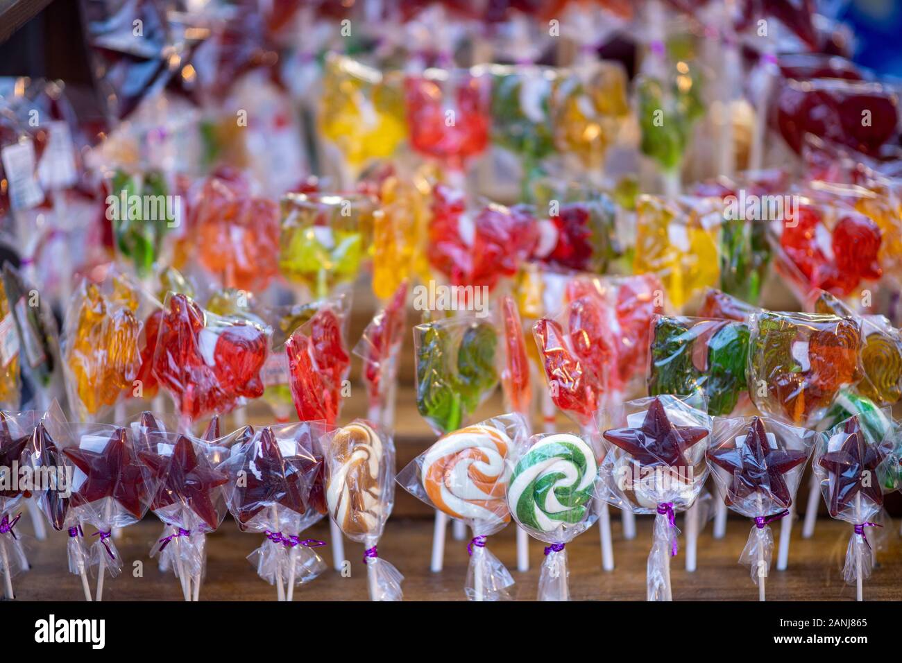 Lot of various multicolored caramel sweets sold at Christmas fair. Colorful lollipops sale in supermarket. Stock Photo
