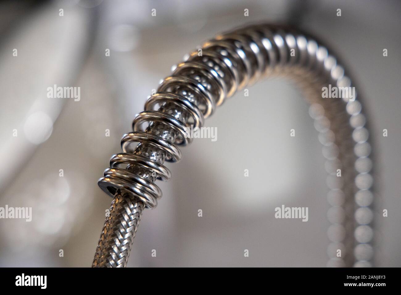 kitchen faucet, detail of metal coil spring. Domestic kitchen. Stock Photo