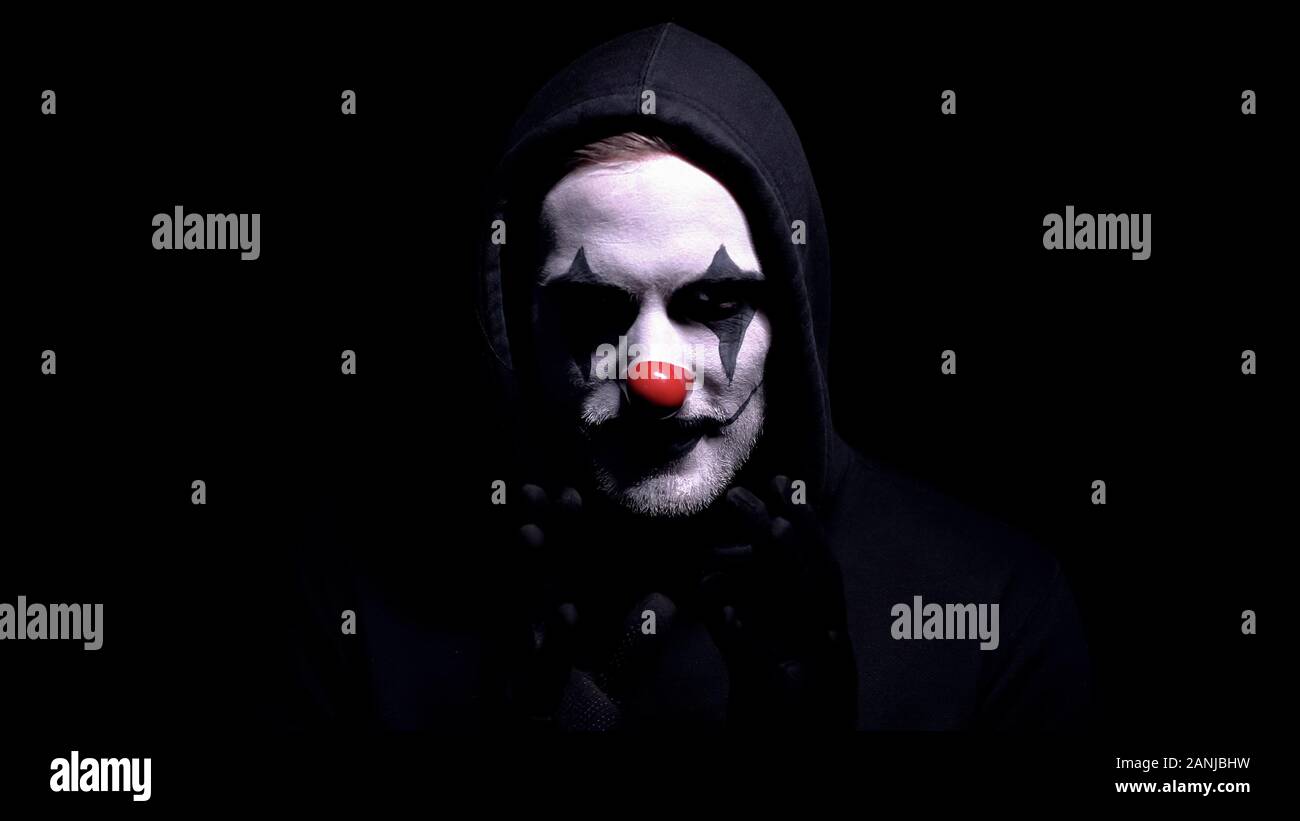 Crazy man in spooky clown mask staring at camera, murder or robbery threat  Stock Photo - Alamy