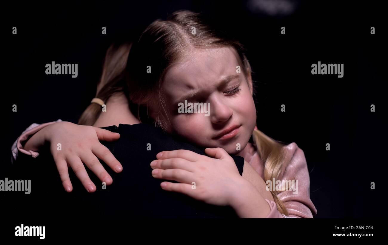 Little female kid hugging mother and crying, victims of kidnapping, fear Stock Photo Alamy