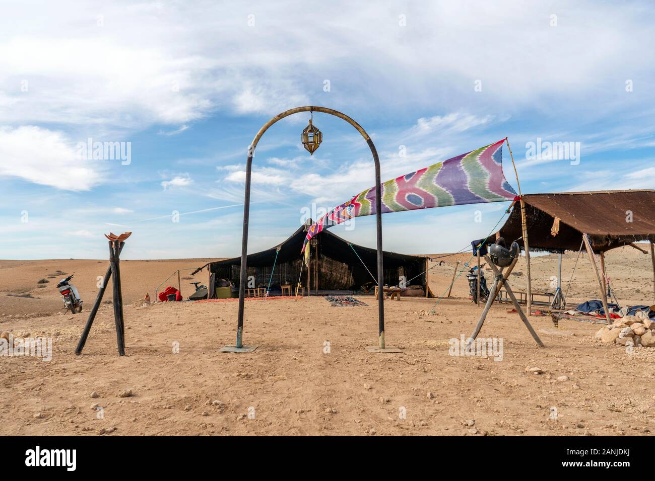 Bedouin settlement with entrance gate and stretch tent on Agafay desert, Morocco Stock Photo