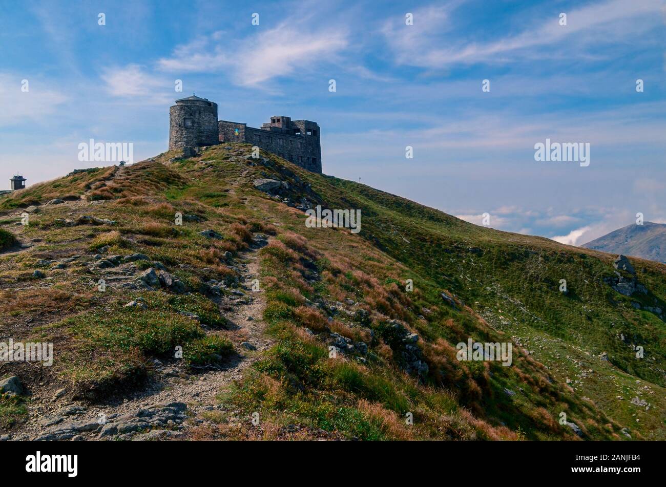 The old stone observatory stands on peak of the Carpathian Mountains Stock Photo