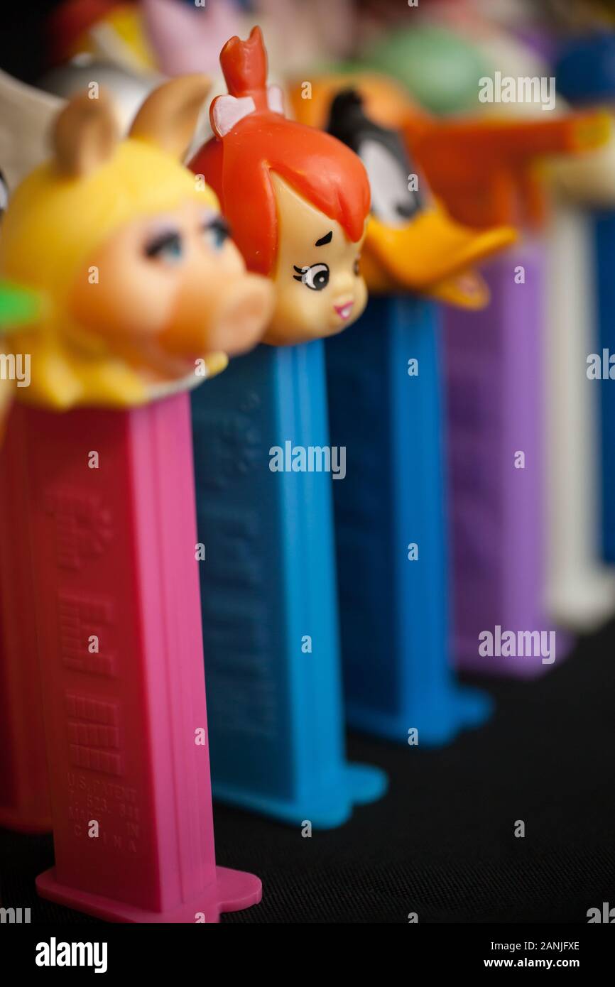 WOODBRIDGE, NEW JERSEY / UNITED STATES - January 16, 2020: A variety of Pez dispensers are lined up on a black background Stock Photo