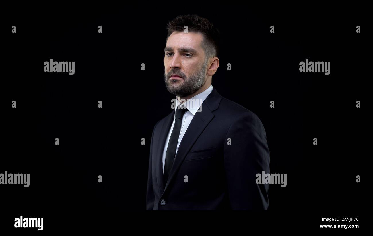 Crying desperate businessman black background, life crisis, mental exhaustion Stock Photo