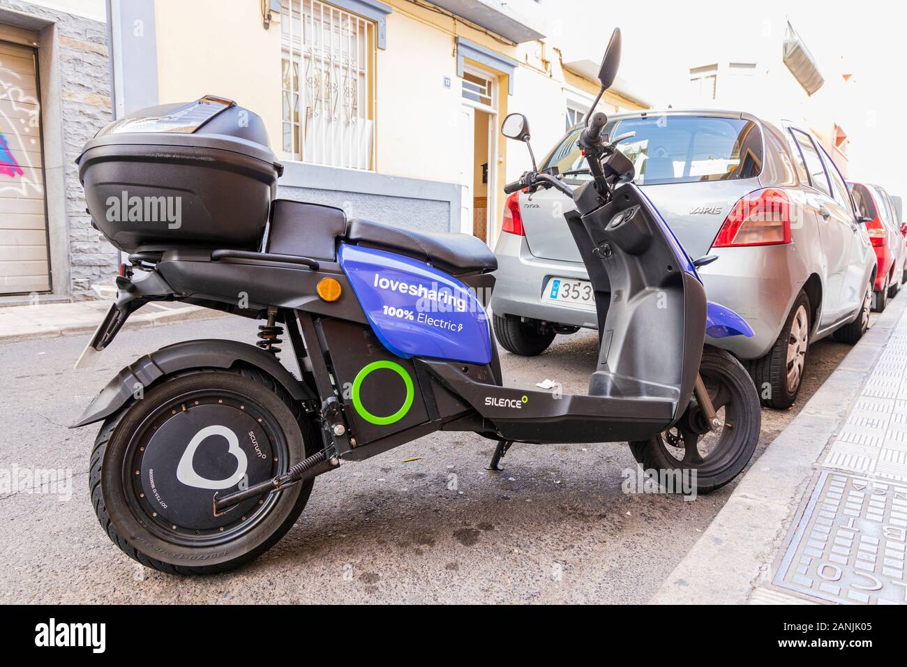 Electric scooter parked in Santa Cruz, available for hire, sharing as part of a sustainable transport scheme in the city, Tenerife, Canary Islands, Sp Stock Photo