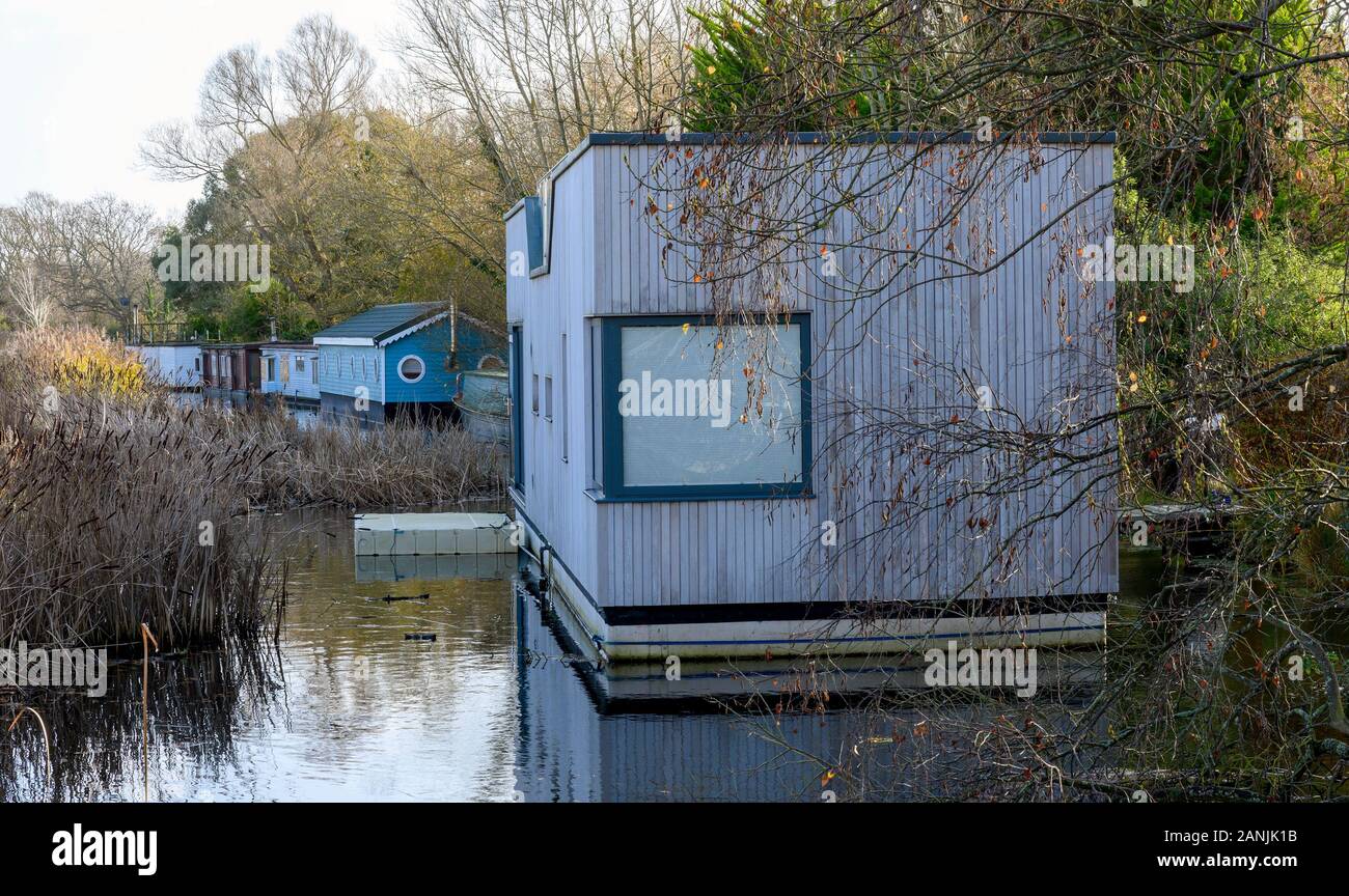 Chichester Canal showing a number of floating homes (residential