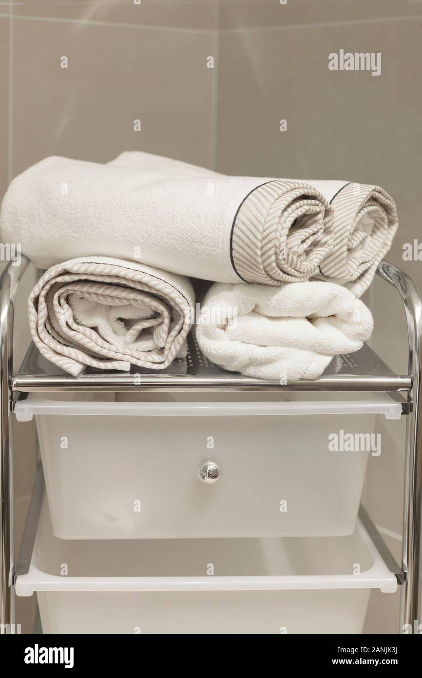 Detail of modern contemporary interior bathroom with towels and shelves