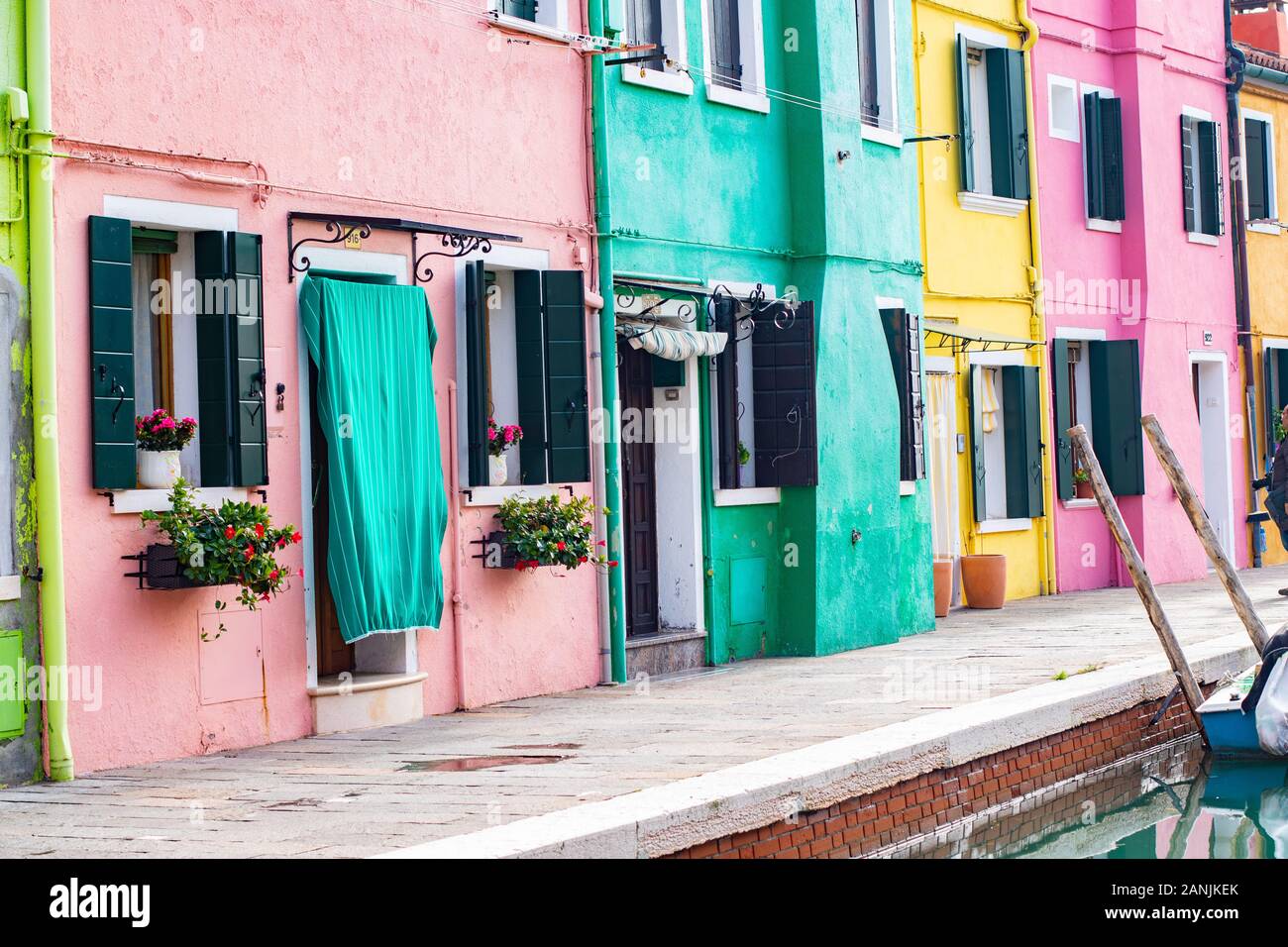 Multi coloured, colourful, colorful houses burano italy, italian architecture, shutters curtains pink yellow green blush facade idyllic summer concept Stock Photo