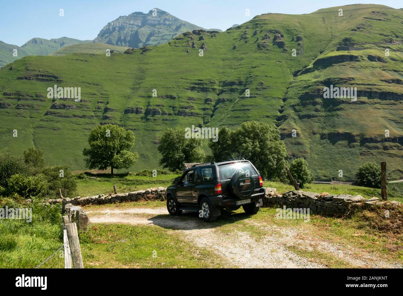Opel Frontera offroad vehicle green laning in Yera valley with Castro Valnera peak in the far end (Vega de Pas, Valles Pasiegos, Cantabria, Spain) Stock Photo