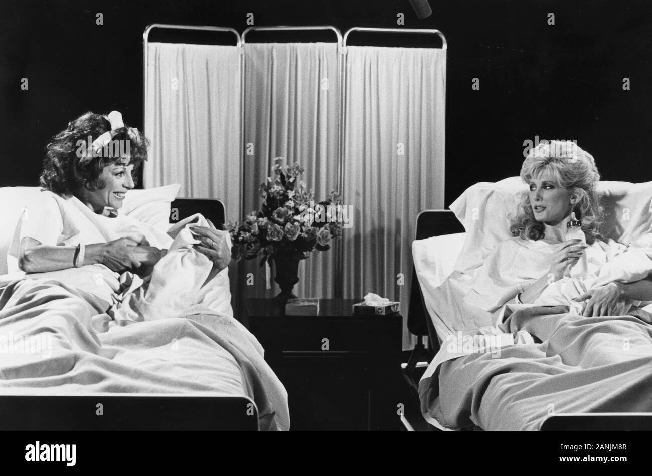 Los Angeles.CA.USA.  LIBRARY.  Joan Collins and Morgan Fairchild appearing in the tv show  Blondes v Brunettes. On set photos taken in April 1984. THe show was broadcast on ABC TV in 14th May 2019.  Ref:LMK30-S011219PBOR-001. Peter Borsari/PIP-Landmark MediaWWW.LMKMEDIA.COM. Stock Photo
