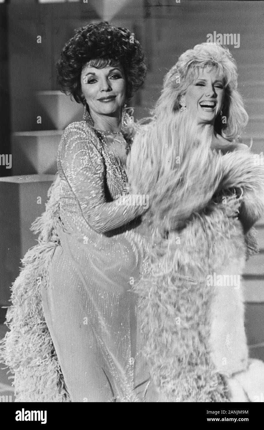 Los Angeles.CA.USA.  LIBRARY.  Joan Collins and Morgan Fairchild appearing in the tv show  Blondes v Brunettes. On set photos taken in April 1984. THe show was broadcast on ABC TV in 14th May 2019.  Ref:LMK30-S011219PBOR-001. Peter Borsari/PIP-Landmark MediaWWW.LMKMEDIA.COM. Stock Photo