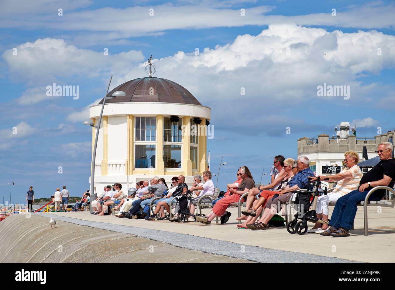 Elderly people relaxing in the sun next to the music pavilion located on the North beach promenade on Borkum Island Stock Photo