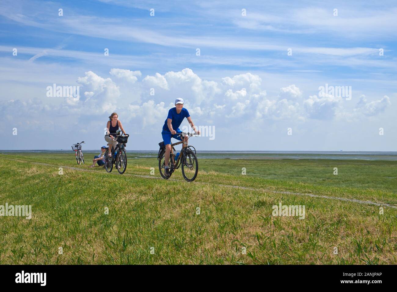 A male and female cyclist biking together on Borkum Island Stock Photo