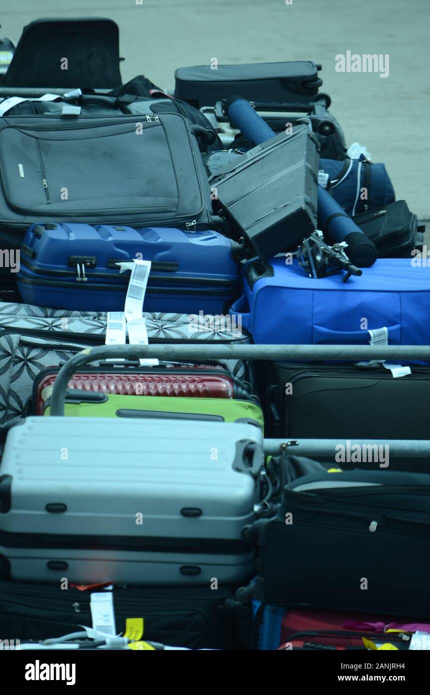airport baggage handlers loading luggage and cargo onto passenger jet